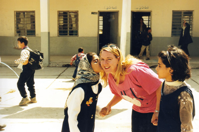 Girl kissing Donna in school yard